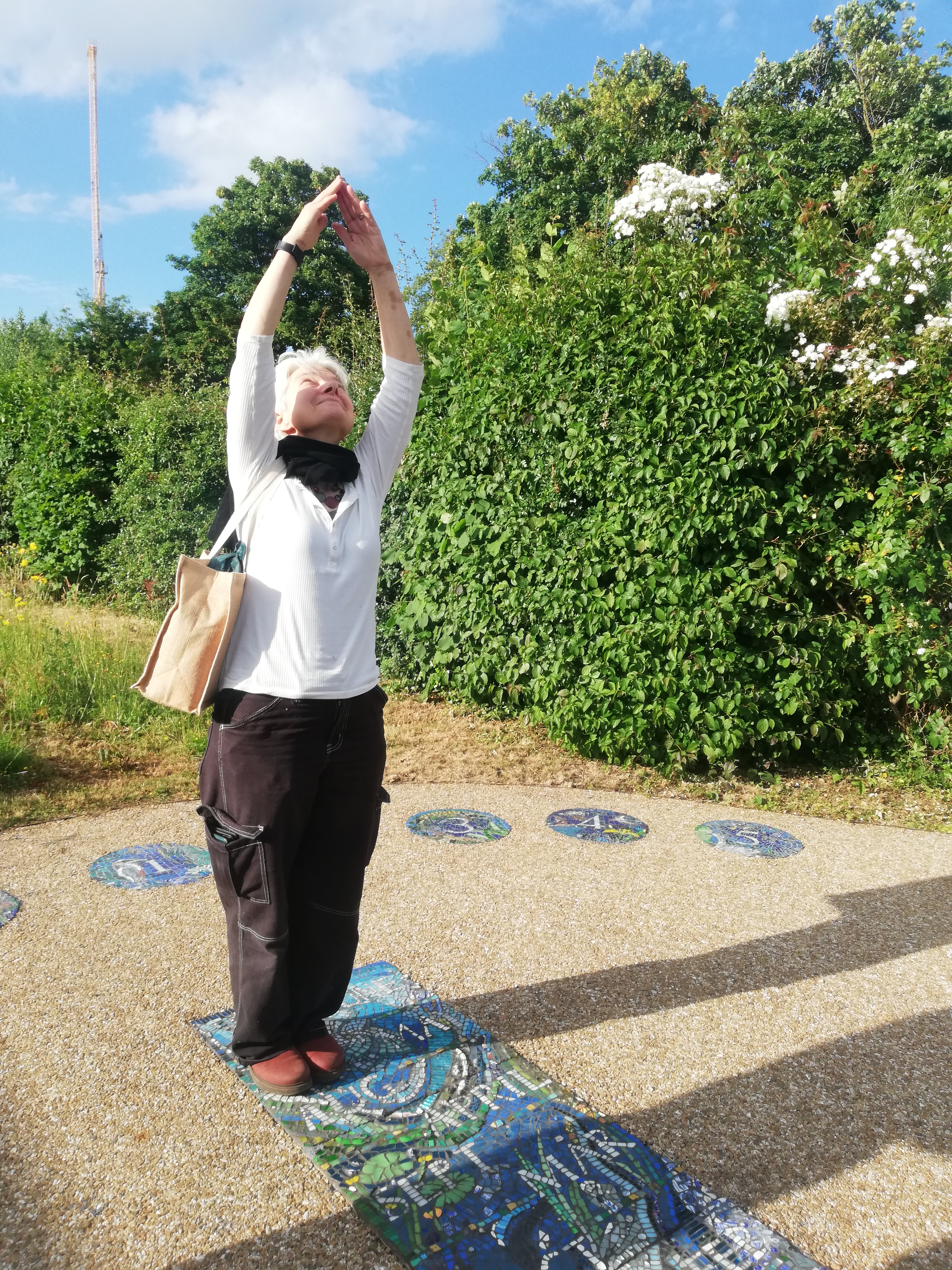 Louise Scott acting as a human sundial on a beautiful mosaic sundial