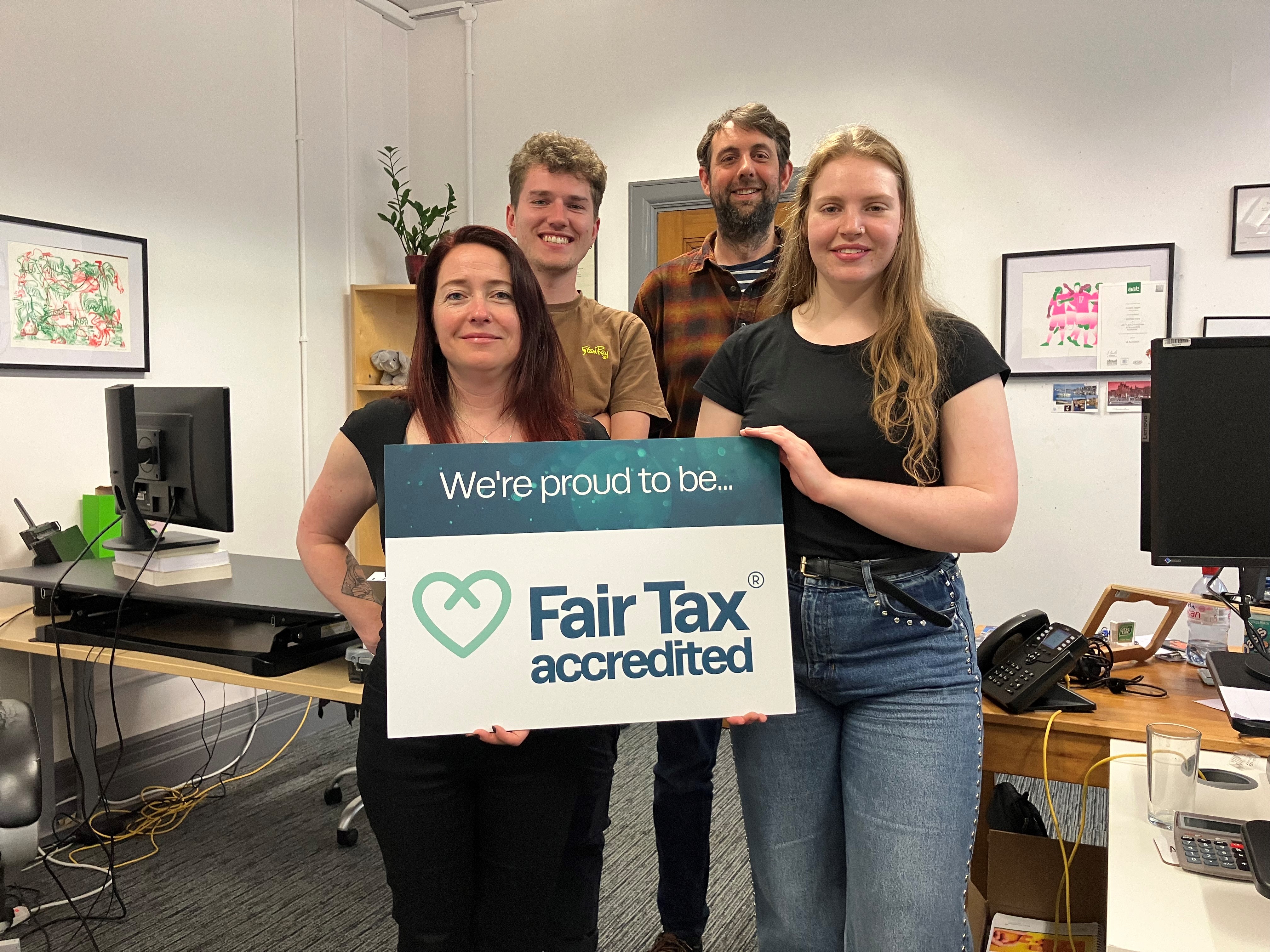Members of Third Sector Accountancy holding a Fair Tax Mark sign