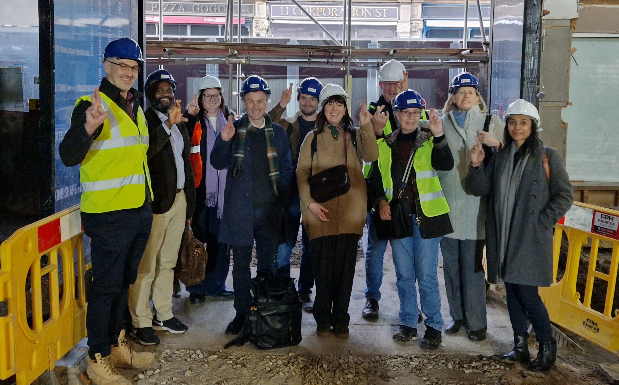 A group of people at the site of the renovations of The Arcade Dewsbury