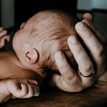 Image showing a baby in someones arms