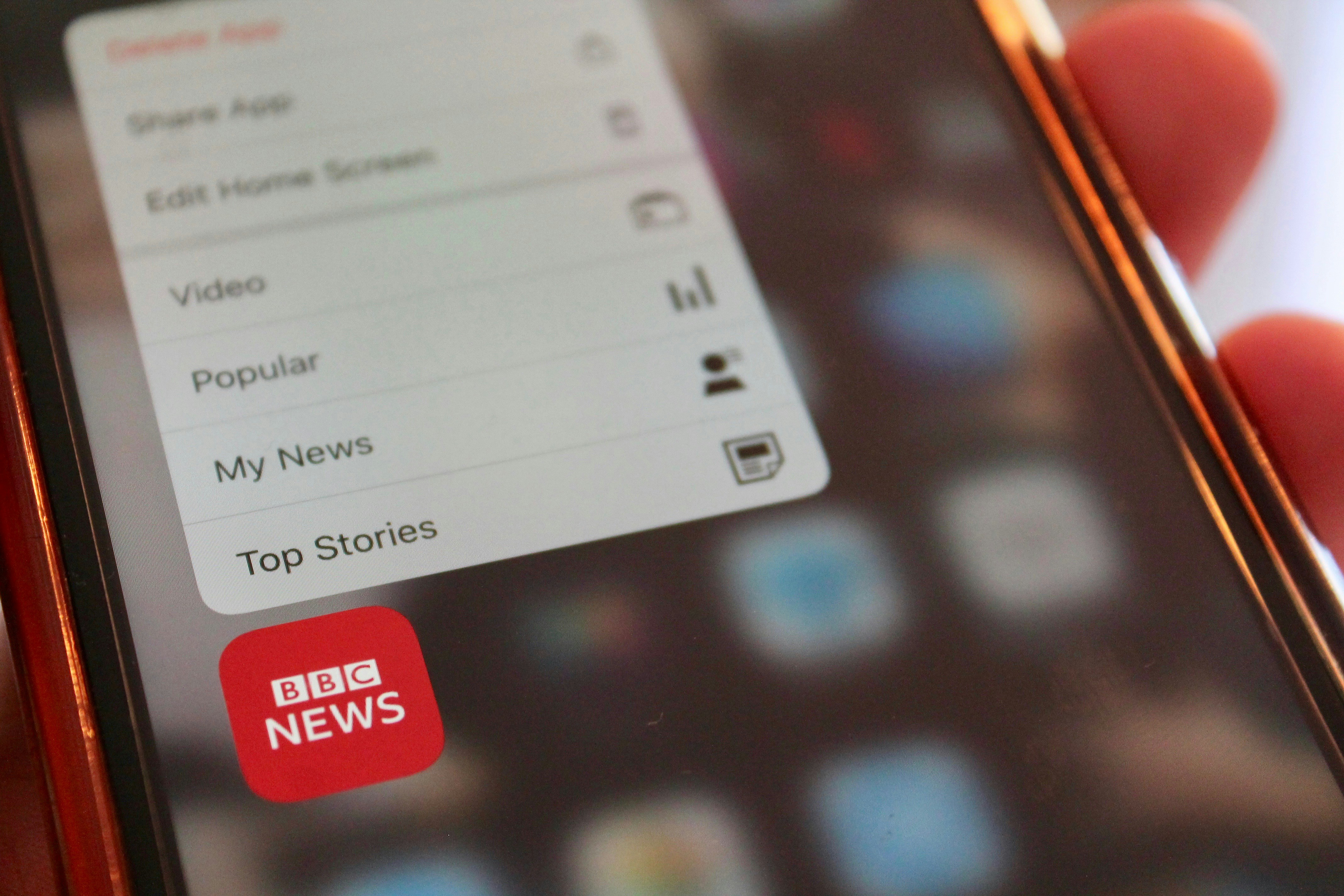 A photograph of a phone displaying the BBC news tab.