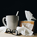 Image of cup, tissues and glasses.
