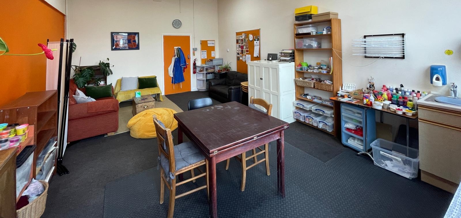 A room with furniture, equipment and art supplies