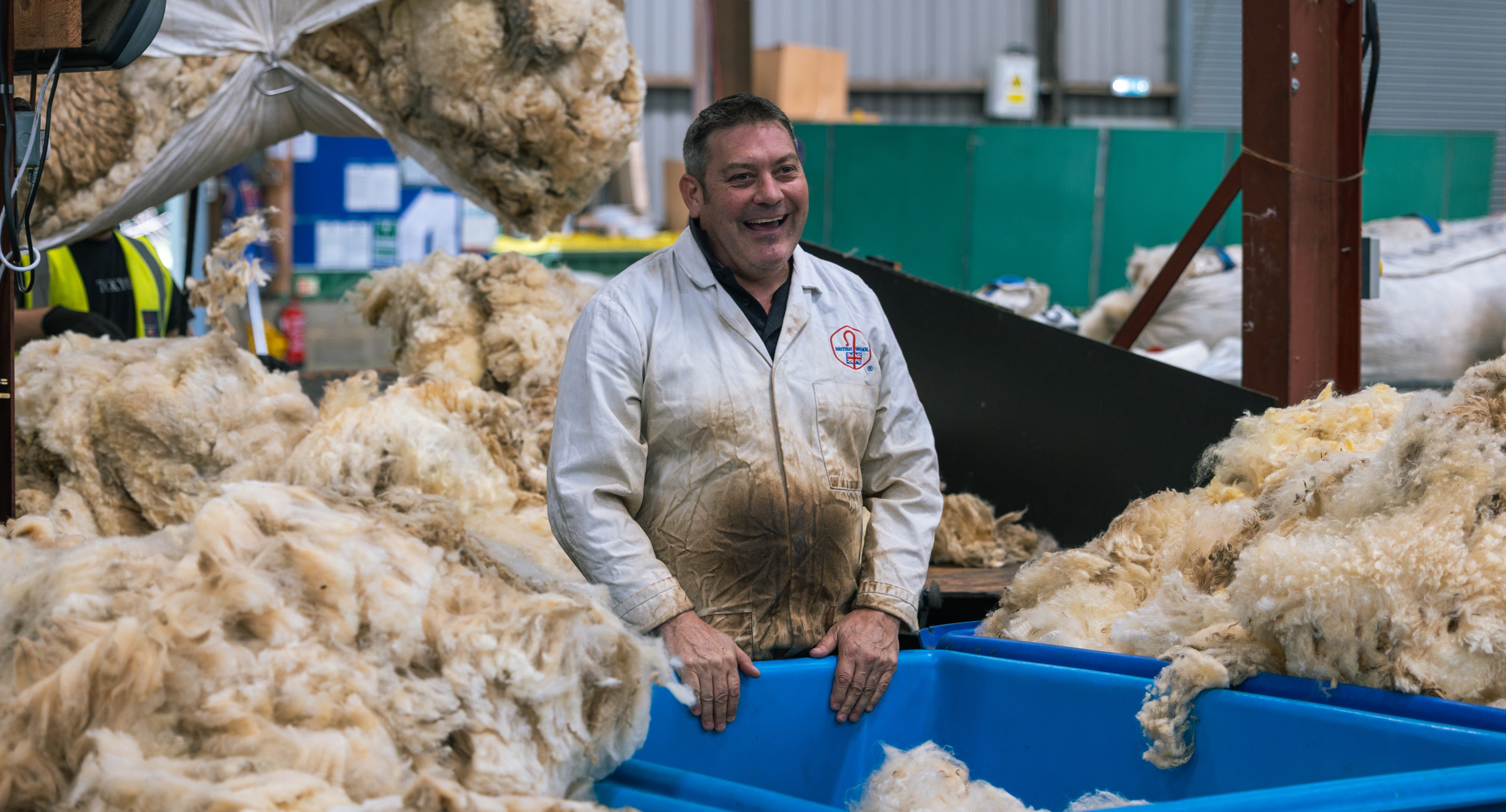 A worker with wool at British Wool