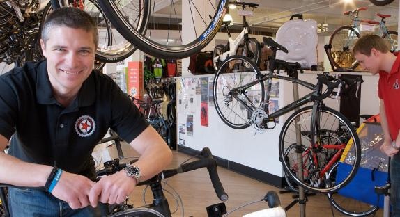 Member of Edinburgh Bicycle Co-op with bikes