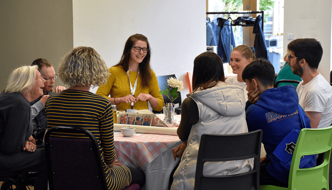 People sat around a table at the Equal Care Co-op AGM