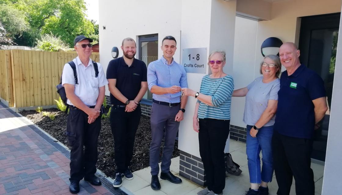 Members of OCLT receive the keys for the completed Crofts Court affordable housing development comprising eight flats. 