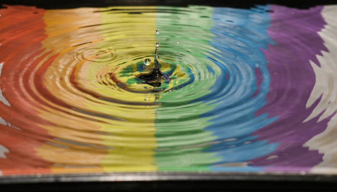 Time lapse photography of a water ripple, showing the colours of the rainbow from left to right. Photo by Jordan McDonald on Unsplash