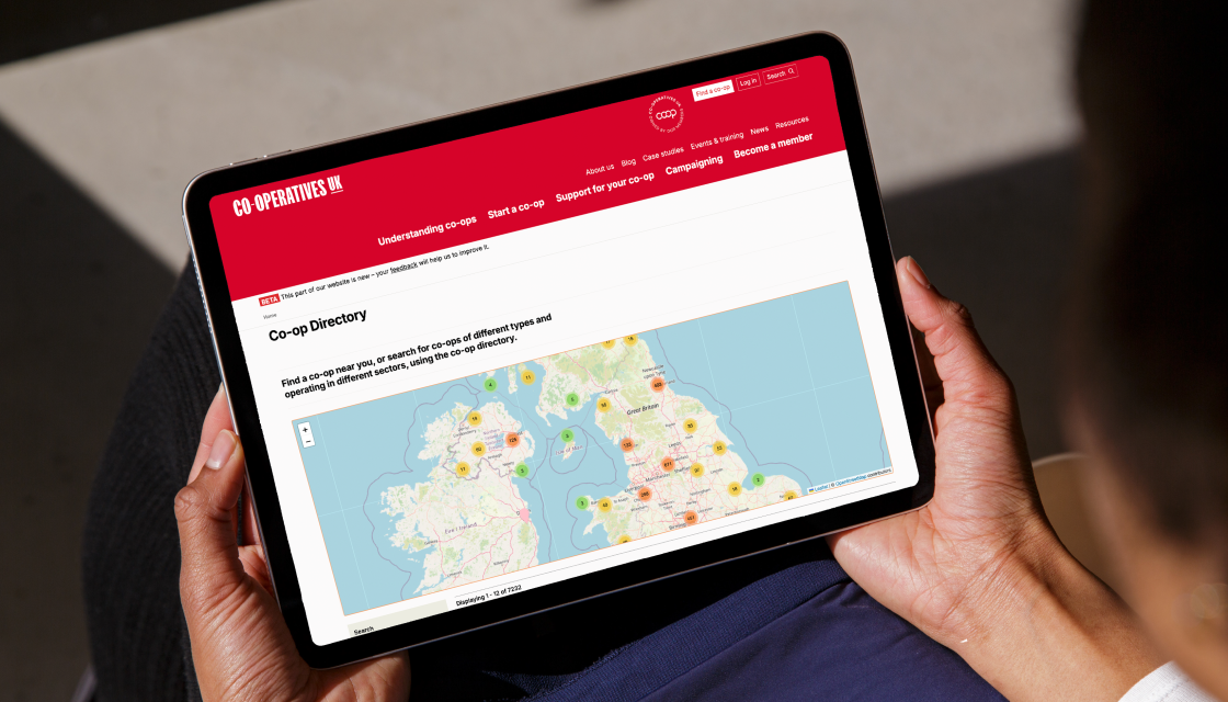 Some holding a tablet device looking at a map of co-operatives on the Co-operatives UK directory