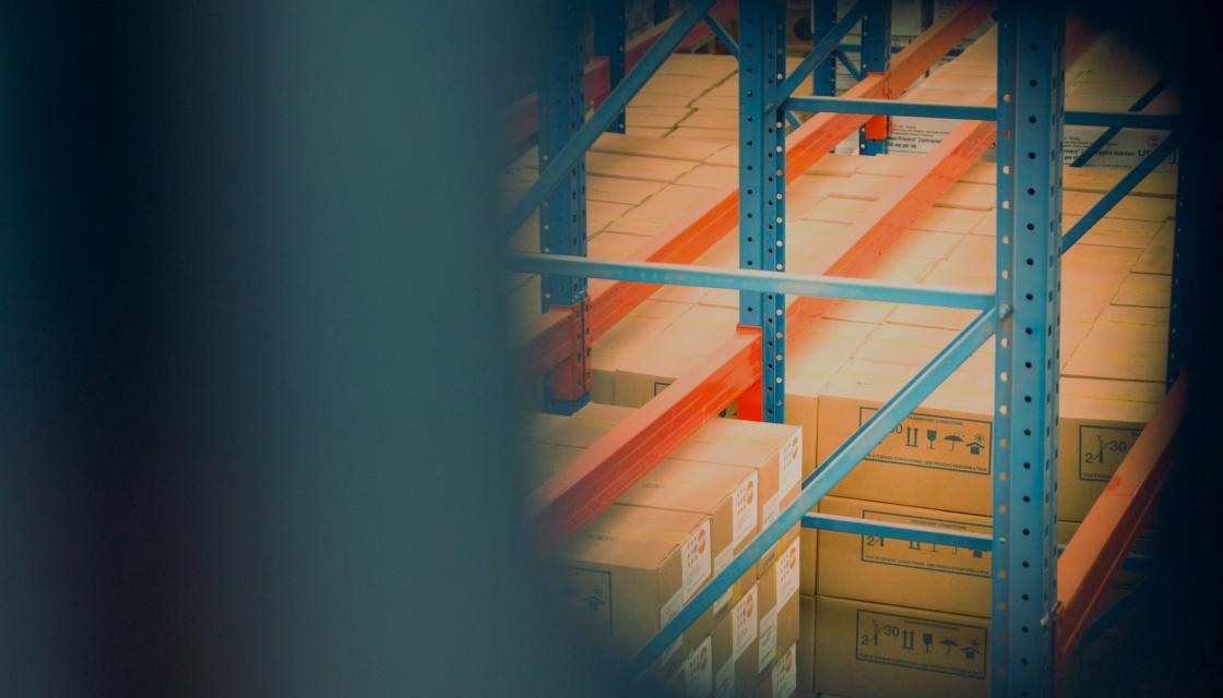 Image of boxes piled in a warehouse