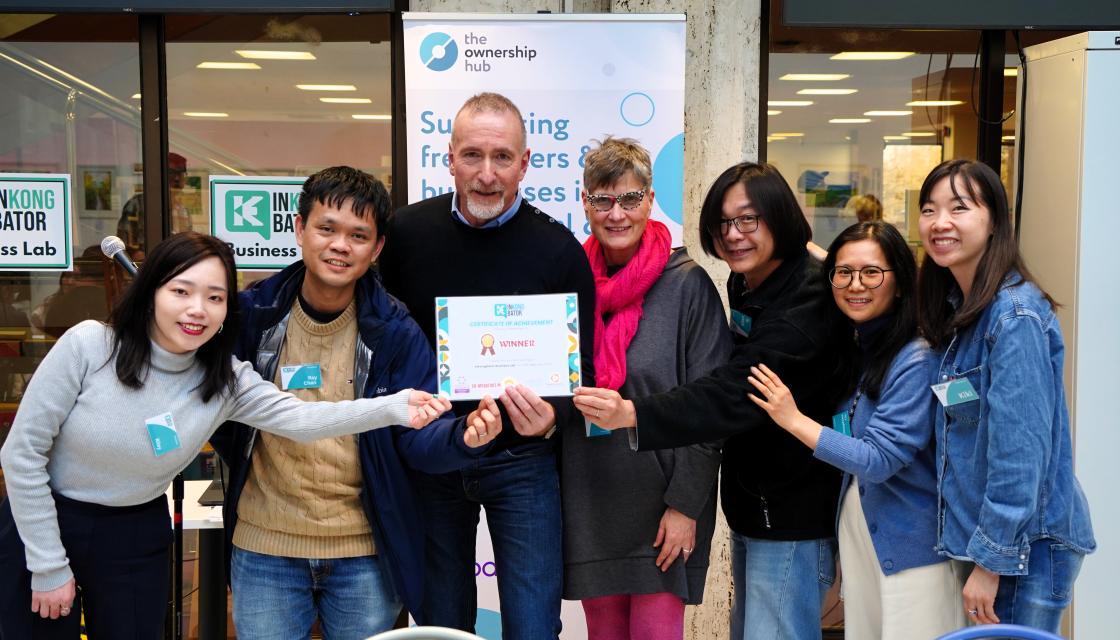 People smiling and holding an achievement certificate an the InKongbator event
