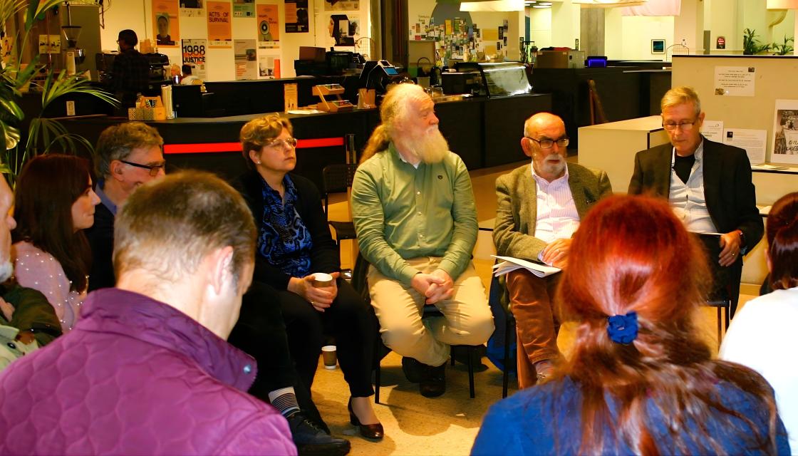 A group of people sat in a circle talking