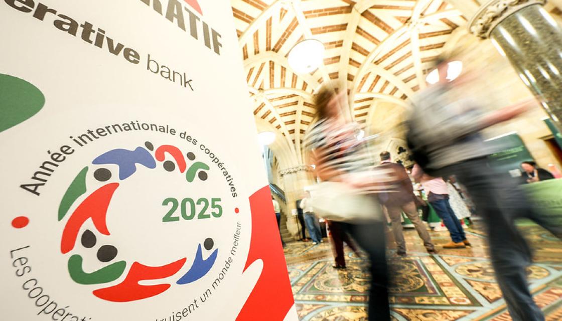 Congress banner with people walking past in a blur