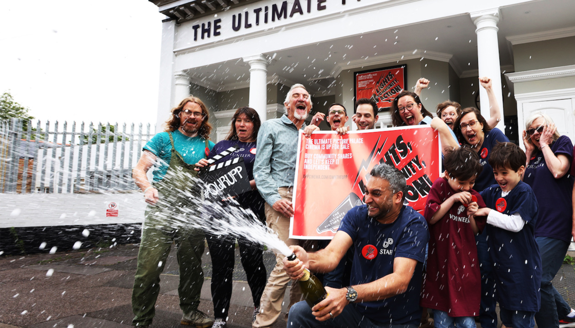 Members of Ultimate Picture Palace celebrating outside the cinema.