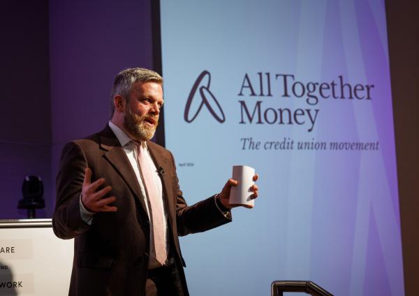 A photograph of Matt Bland, Chief Executive of All Together Money speaking at the organisation's rebrand event.