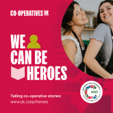 A banner promoting a storytelling guide 'We Can Be Heroes' with an image of two women from a co-operative smiling at the camera