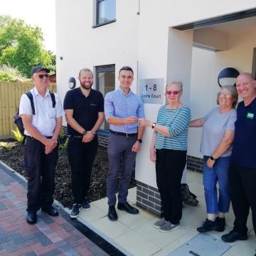 Members of OCLT receive the keys for the completed Crofts Court affordable housing development comprising eight flats. 
