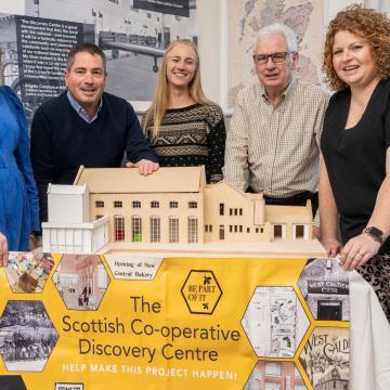 People stand with a model of the soon to be redeveloped Scottish Co-operative Discovery Centre