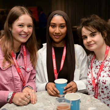 Three smiling attendees at the National Youth 