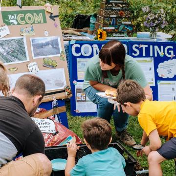 Children and adults learning about composting