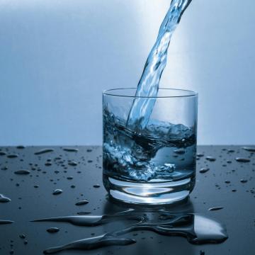 Photograph of water being poured into a glass of water
