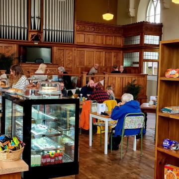 People dining in the cafe of the renovated Cotherstone Old Chapel