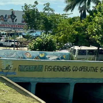 A photo of a bridge in Jamaica with the writing "Fishermans Co-operative Society Limited"