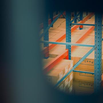 Image of boxes piled in a warehouse