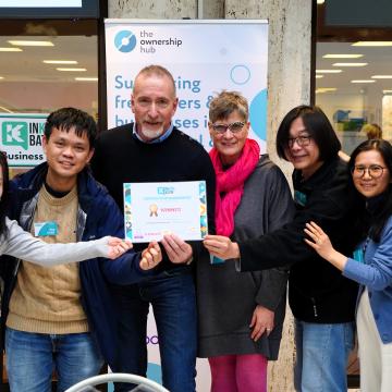 People smiling and holding an achievement certificate an the InKongbator event