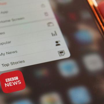 A photograph of a phone displaying the BBC news tab.