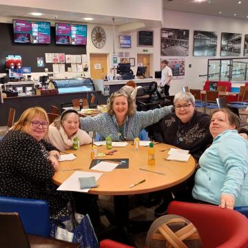 People around a table at a bowling alley