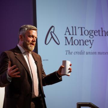 A photograph of Matt Bland, Chief Executive of All Together Money speaking at the organisation's rebrand event.