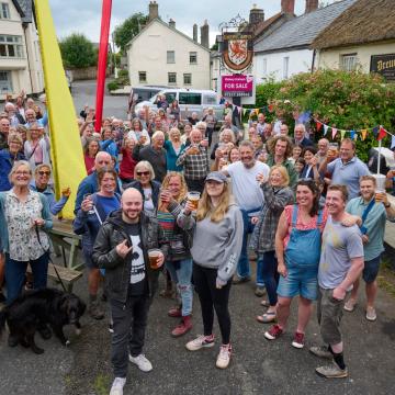 A picture showing people outside of the Drewes Arms pub